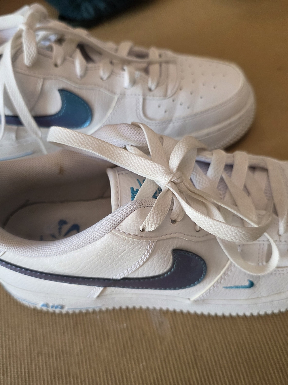 Nike Kids White Sneakers with Blue Swoosh Accents